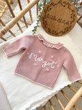 Pink frilly cardigan - (add to notes the name & hearts or roses around the name)