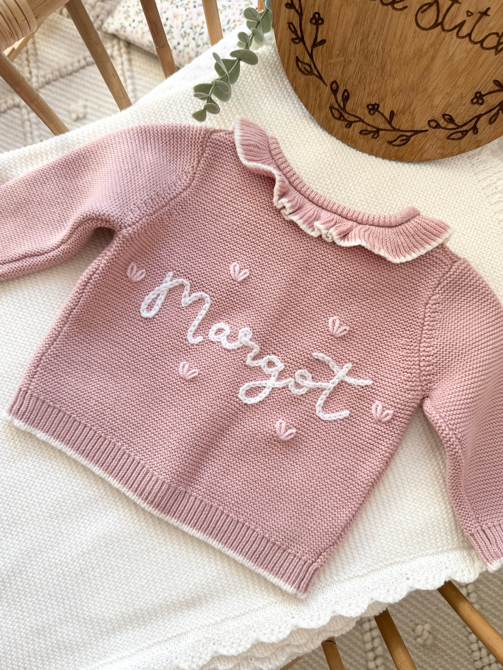Pink frilly cardigan - (add to notes the name & hearts or roses around the name)