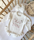 She’s here or 1 single name and rose design frilly romper