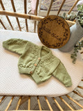Green newborn handknitted cardigan